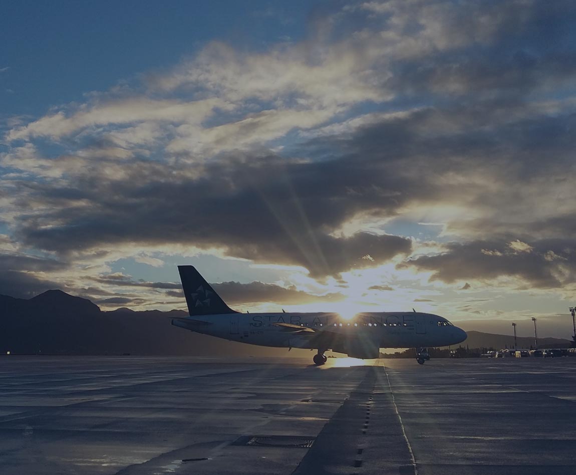 plane on the tarmac with a sunset